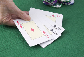 image of a man holding playing cards